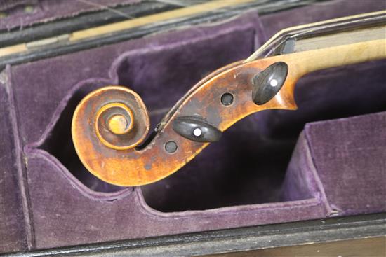 A cased violin and bows
